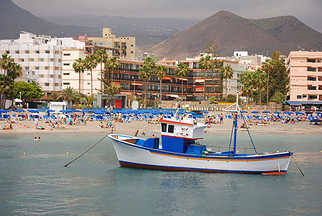 Boat in front of Tenerife beach hotels photo