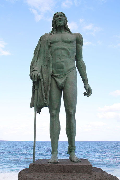 Guanche bronze statue by the ocean Canary islands photo